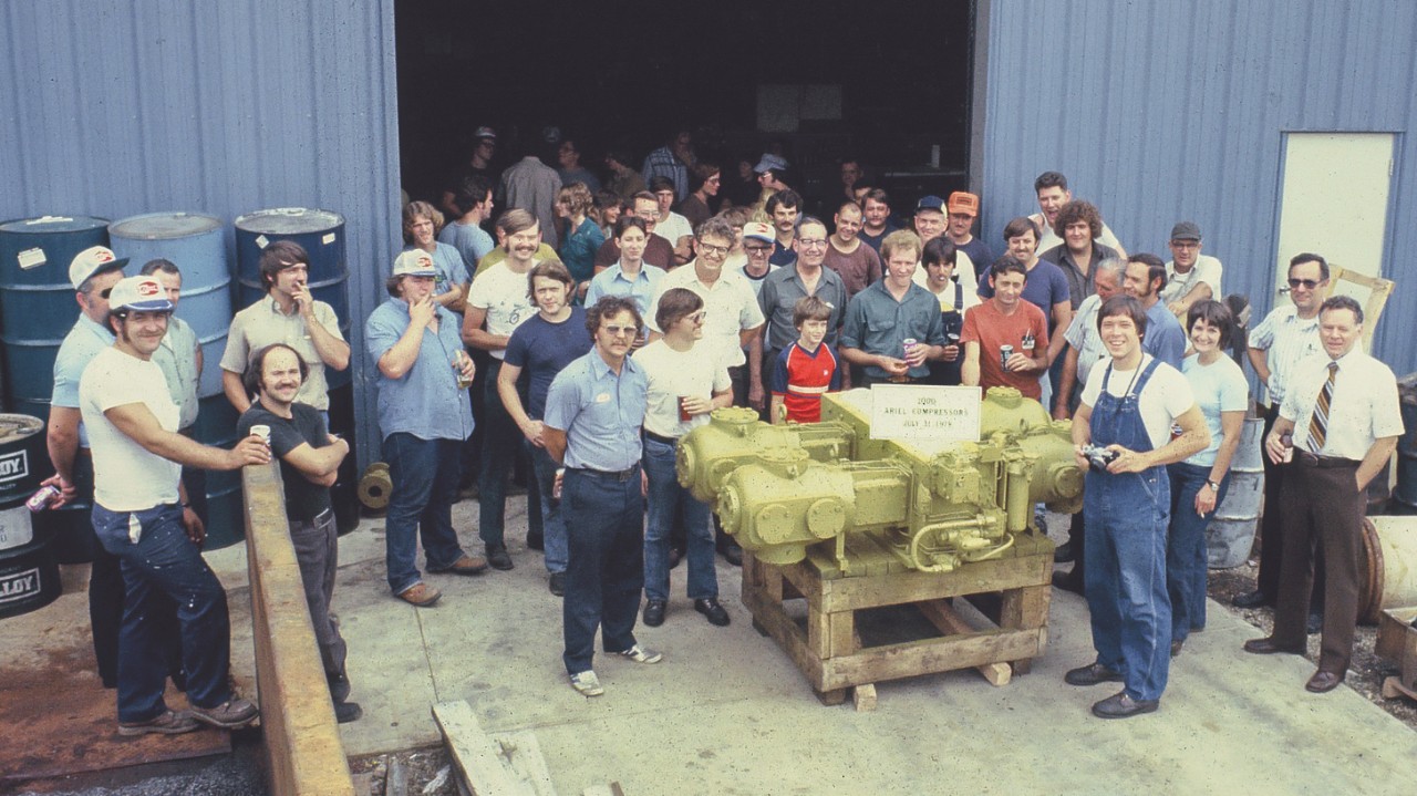 Historic image of employees standing around the 1000th Ariel compressor