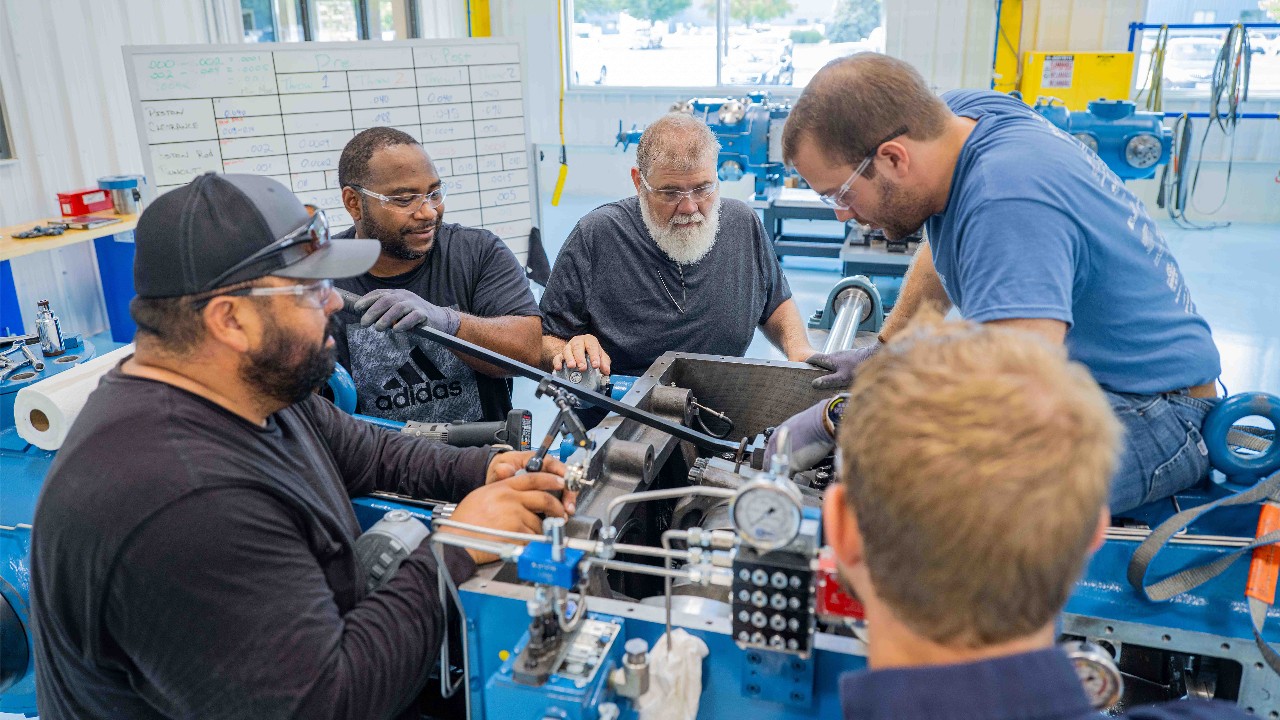 Customers training in the Ariel training lab on a compressor. 